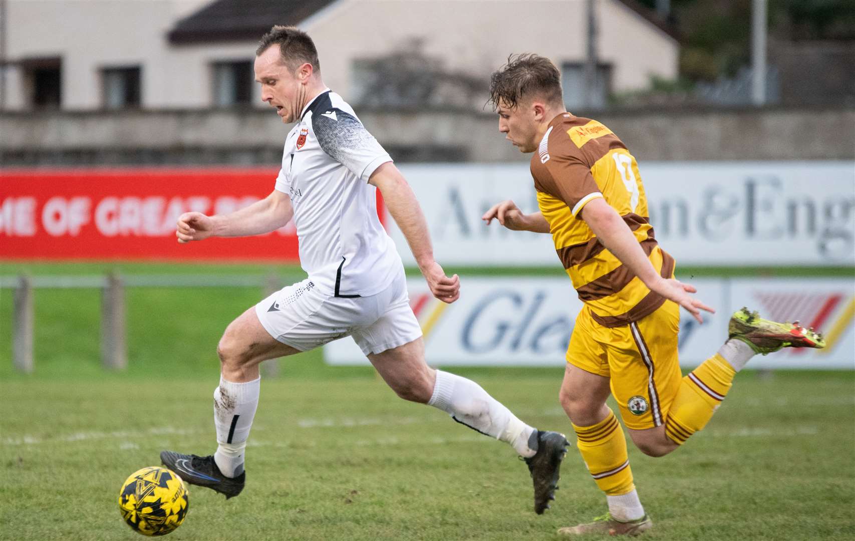 Rothes centre back Charlie MacDonald battles with Forres' Shaun Morrison. ..Forres Mechanics FC (0) vs Rothes FC (1) - Highland Football League 23/24 - Mosset Park, Forres 25/11/2023...Picture: Daniel Forsyth..