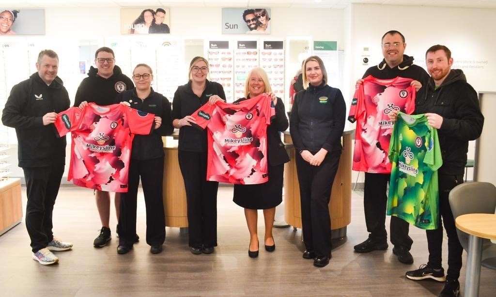 Moray Mental Health players with shirts inside Elgin's Specsavers.