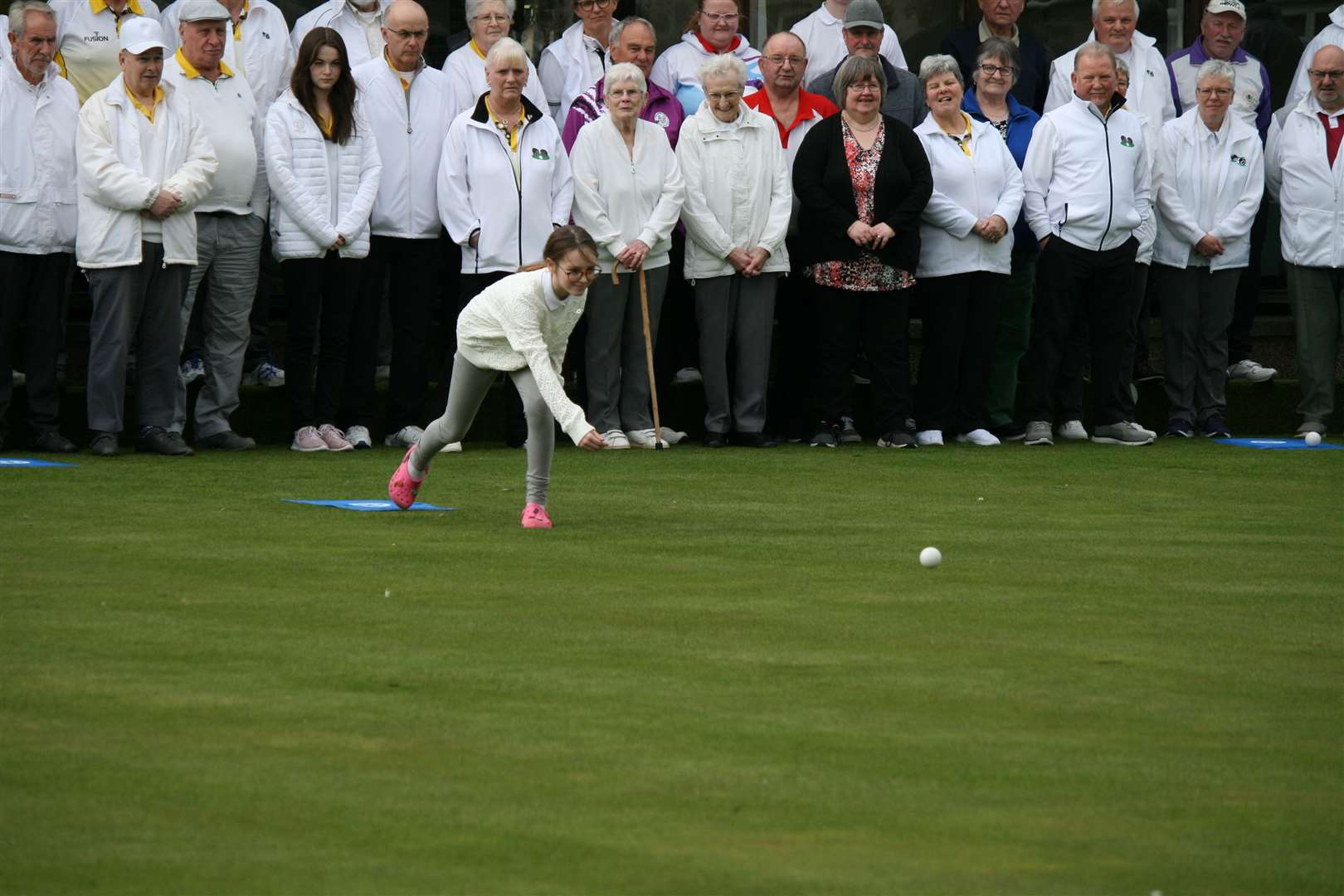 Ten-year-old Charley Dustan officially opens the Forres Bowling Club season by rolling out the first jack.