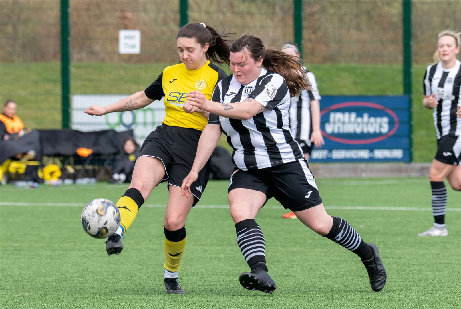 Elgin City forward Emma Craig tussles with Stonehaven's Taylor Clark.Picture: Daniel Forsyth.