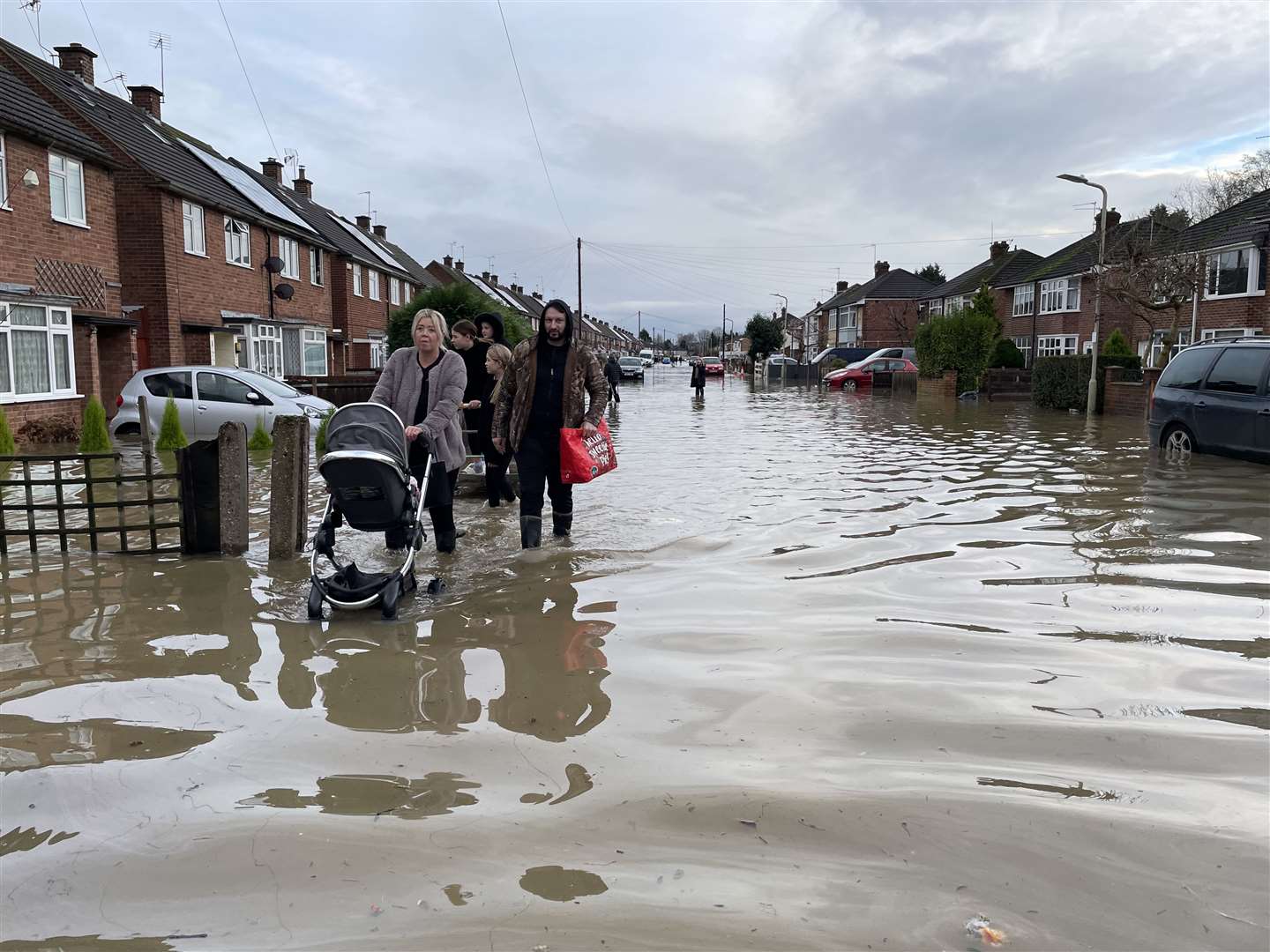 Residents wade through flood water in Loughborough, Leicestershire (Callum Parke/PA)