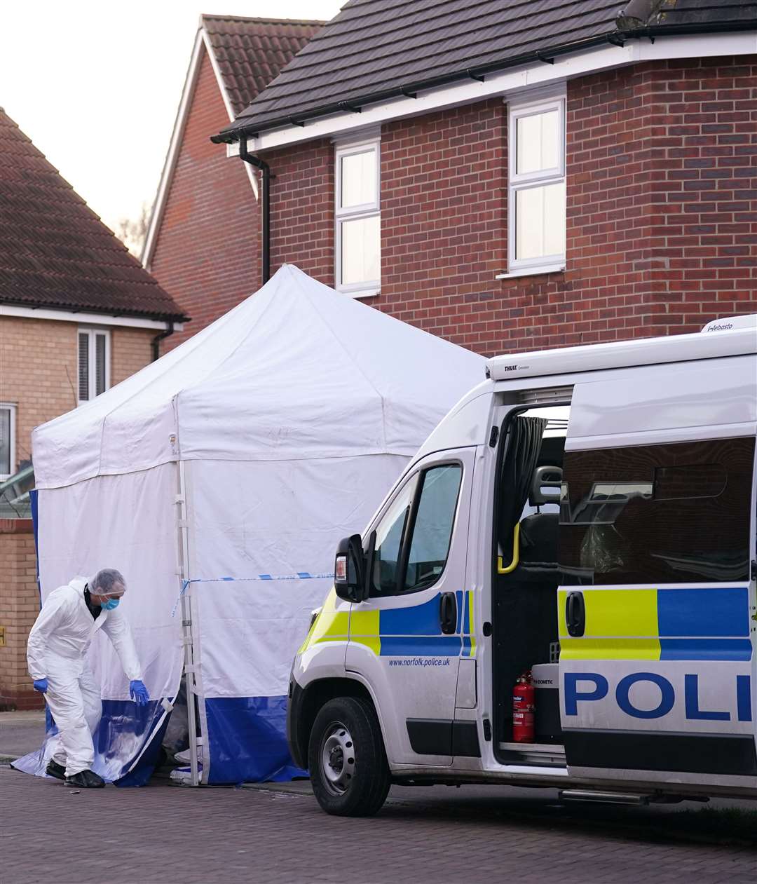A forensic investigator outside a house in Costessey (Joe Giddens/PA)