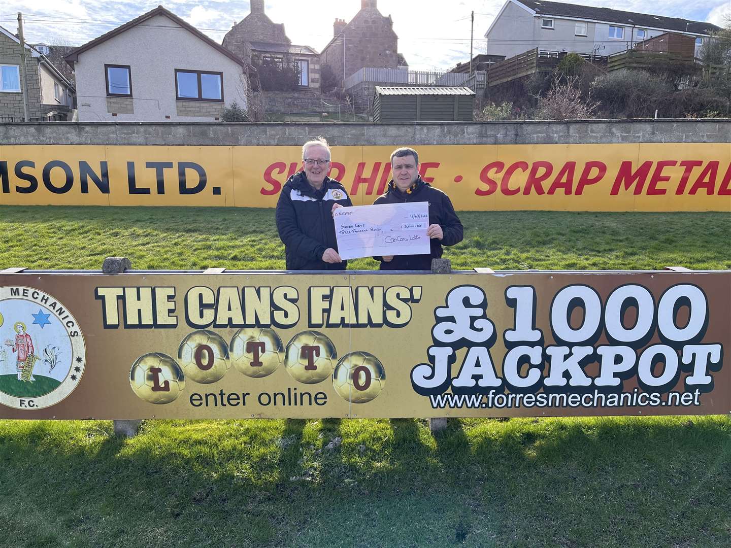 Stephen Levy (right) has won the £3000 jackpot in the Cans Lotto and was presented with his cheque by Sandy Dow.