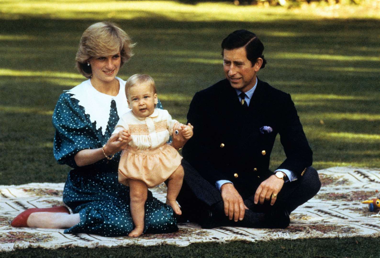 The Prince and Princess of Wales amuse baby Prince William in the grounds of Government House in Auckland, New Zealand in 1983 (PA)