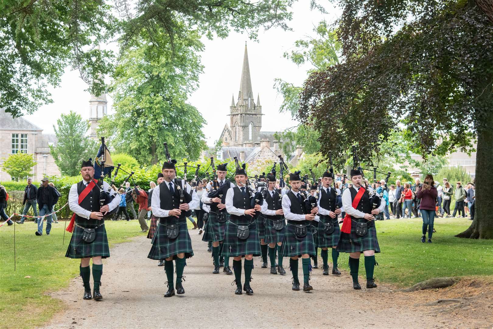 The Forres and District Pipe Band march in to Grant Park ahead of the offical opening of the games...Forres Highland Games 2022...Picture: Daniel Forsyth..