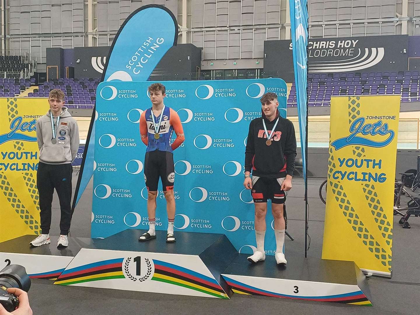 Lewis Dey (right) on the podium at the Emirates Arena in Glasgow.