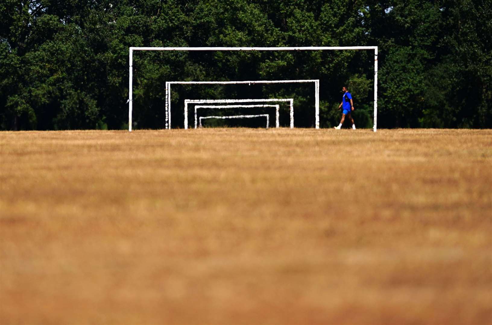 Dry grass on the football pitches at Hackney Marshes (Victoria Jones/PA)