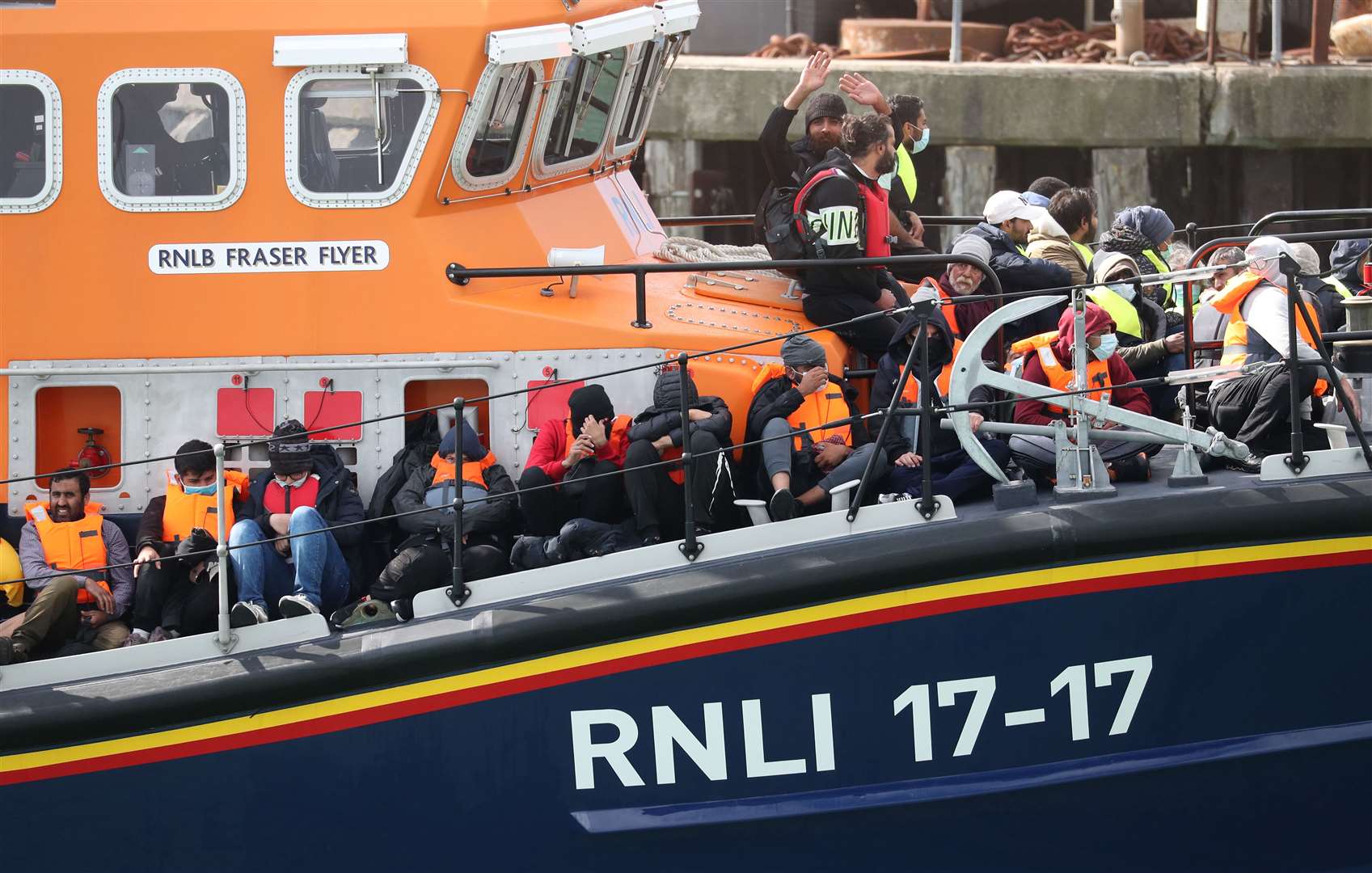 A group of people thought to be migrants are brought into Dover, Kent, by the RNLI on Wednesday