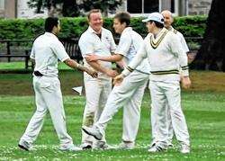 John Duff gets congratulated for his bowling against Fochabers.