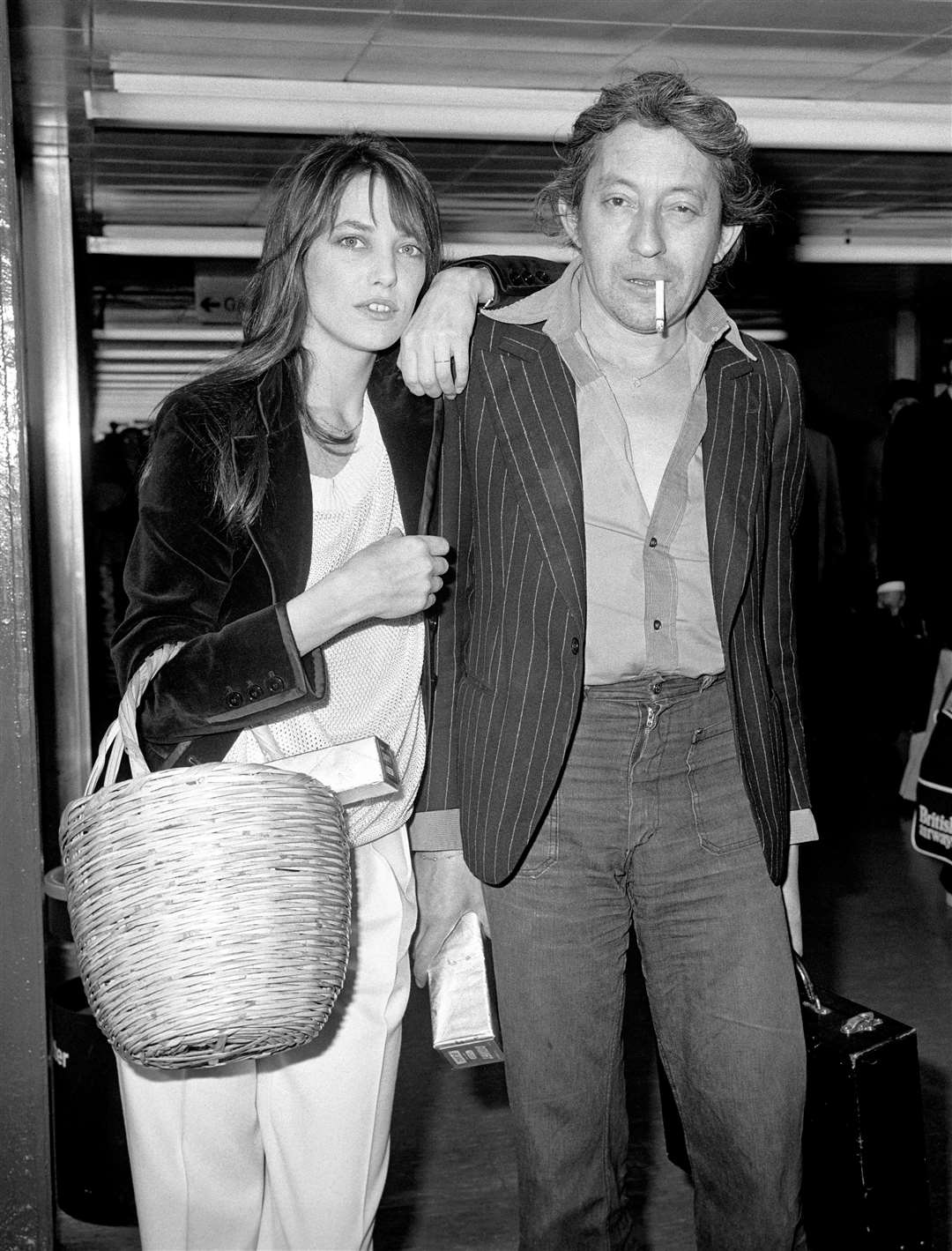 Jane Birkin with Serge Gainsbourg at London’s Heathrow Airport in 1977(PA)