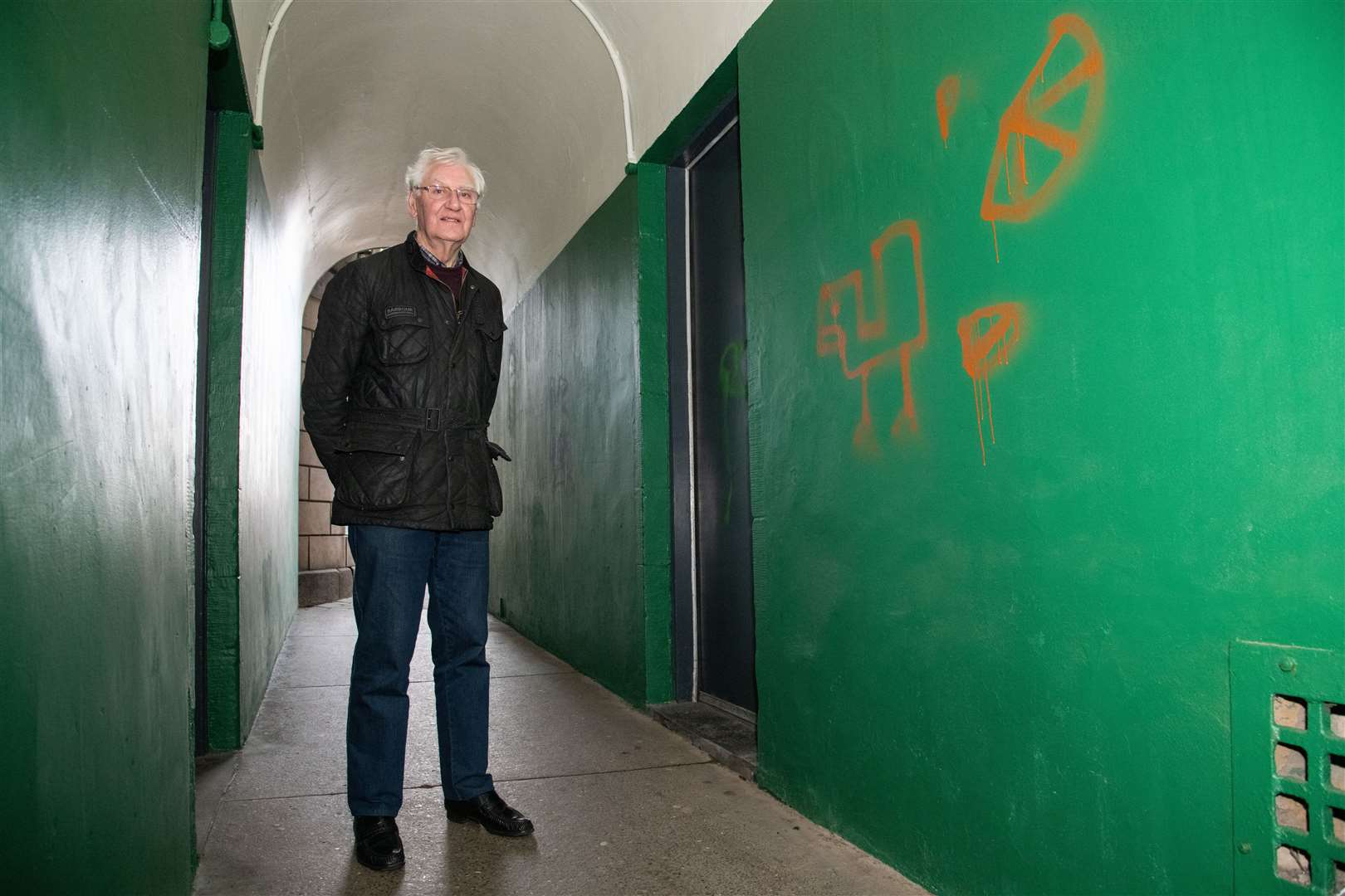 Forres Heritage Trust volunteer Tom Logie inspecting vandalism in Bobbie’s Bow that has since been removed.