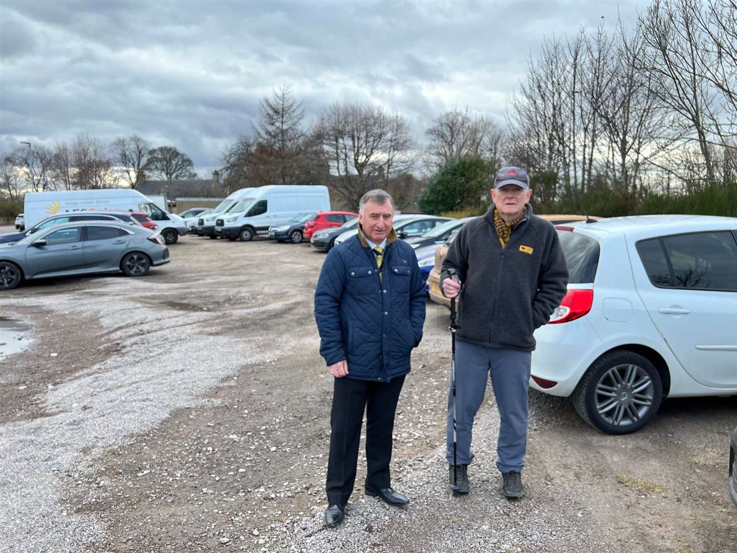 Dave Macdonald (Forres Mechanics chairman, left) joins Don Wright, Mechanics supporter, at the car park outside Mosset Park.