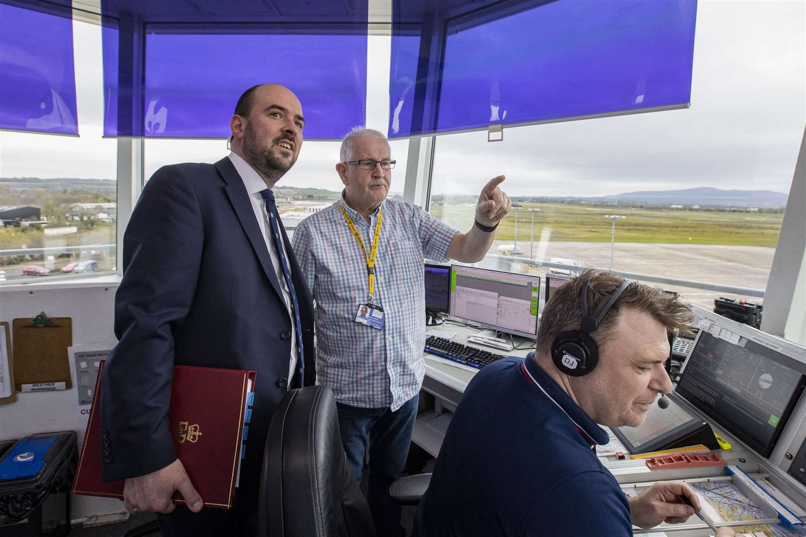 Transport Minister Richard Holden (left) with Air Traffic Controller Alistiar Hunter (centre), during a visit to the City of Derry Airport (Liam McBurney/PA)