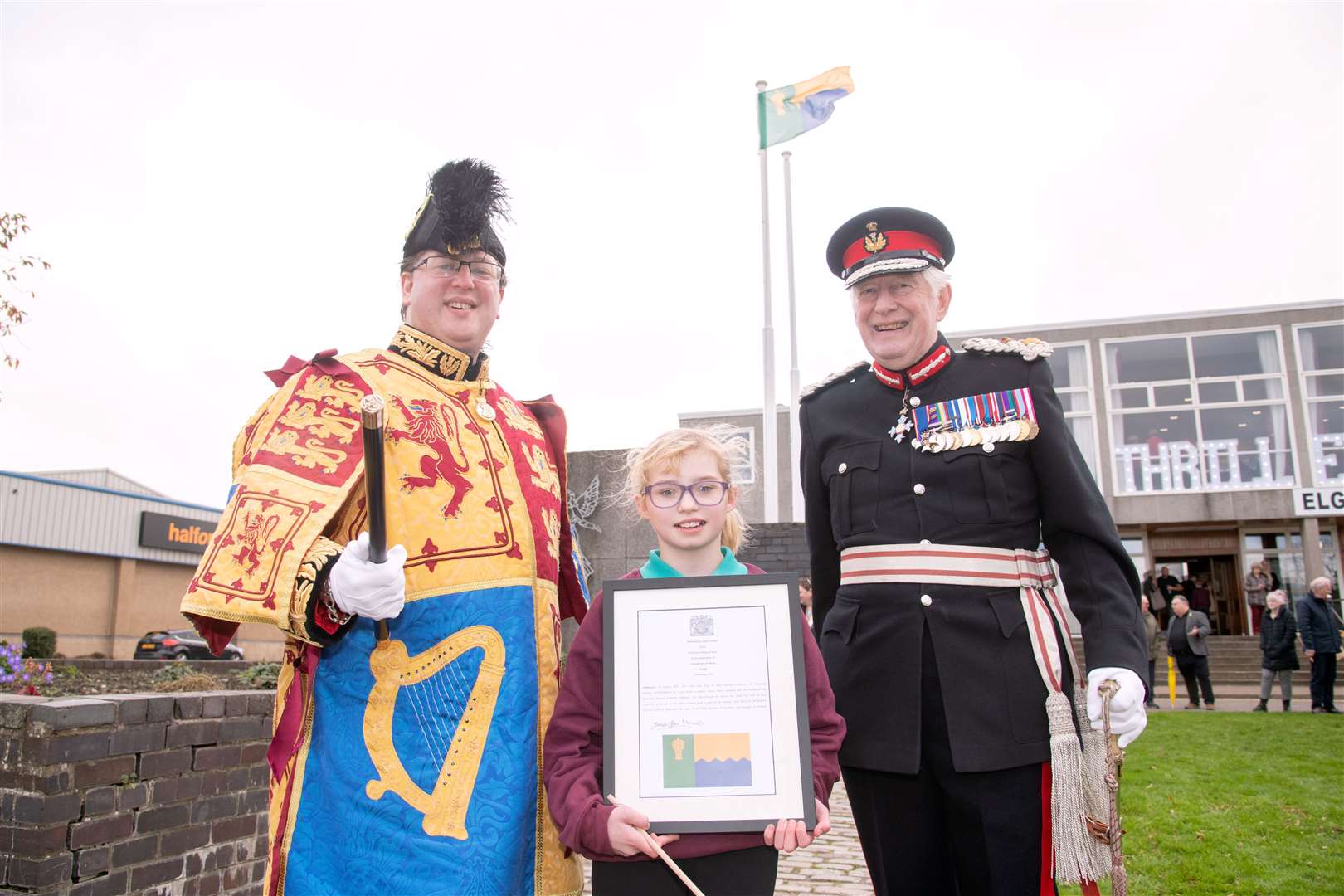 From left; Philip Tibbetts (Lyon Court Vexillologist for Scotland), Aila Gibson and Lord Lieutenant of Moray Seymour Monro...The Moray flag is unveiled during a ceremony outside the Elgin Town Hall. ..Picture: Daniel Forsyth..