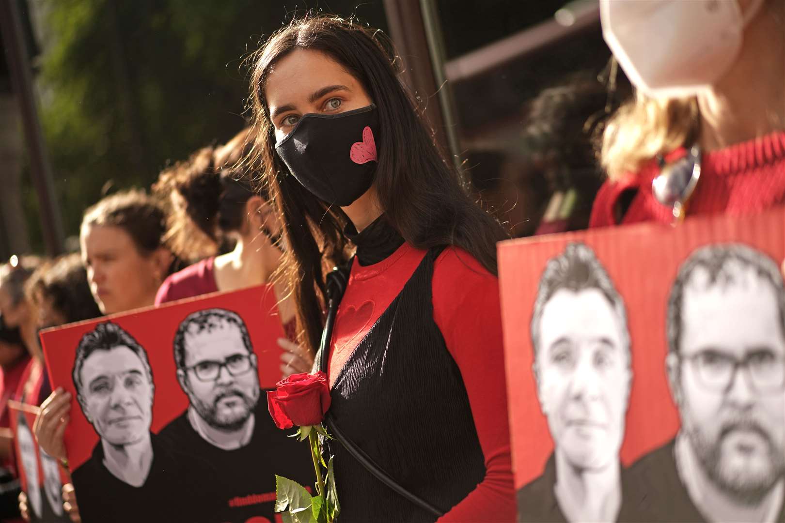 People take part in a vigil outside the Brazilian Embassy in London (Victoria Jones/PA)