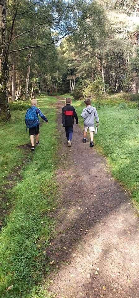 Young FASS players walking through the woods.