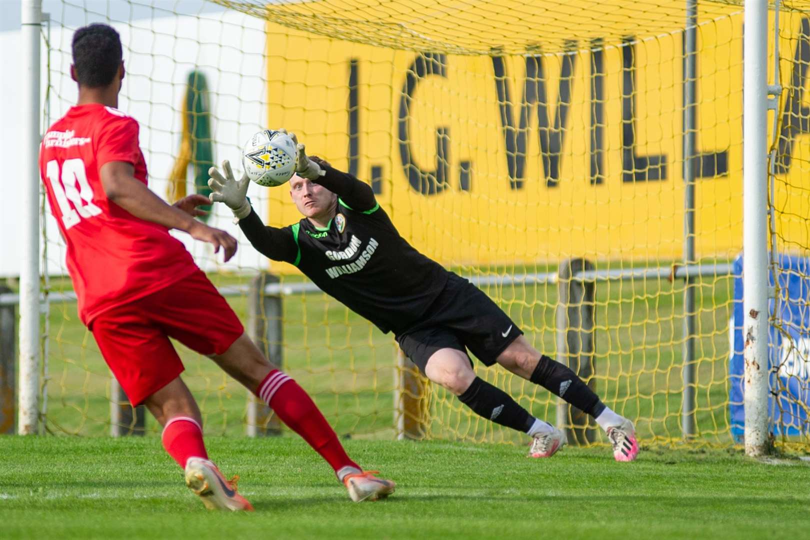 Forres keeper Paul Robertson saves this Lossie effort...Forres Mechanics FC (1) vs Lossiemouth FC (0) - Highland Football League - Mosset Park, Forres 28/08/2021...Picture: Daniel Forsyth..