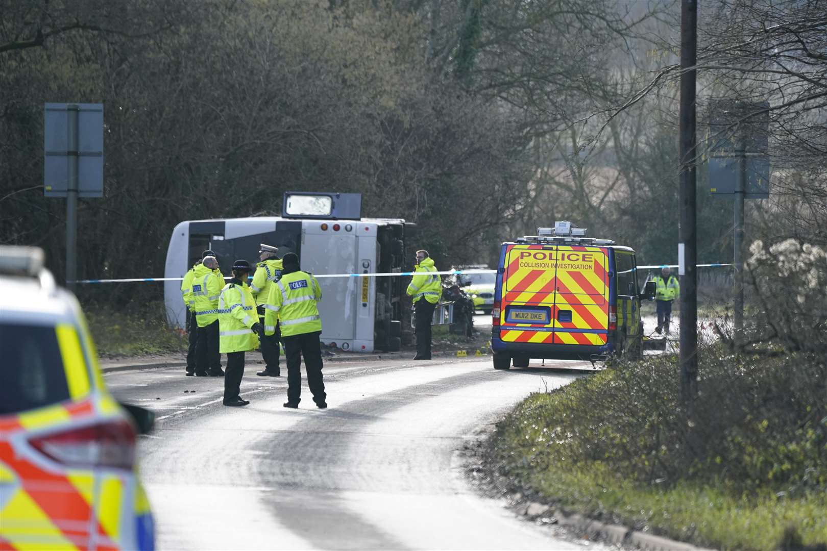 Police at the scene on the A39 Quantock Road in Bridgwater after a double-decker bus overturned in a crash involving a motorcycle. (Andrew Matthews/PA)