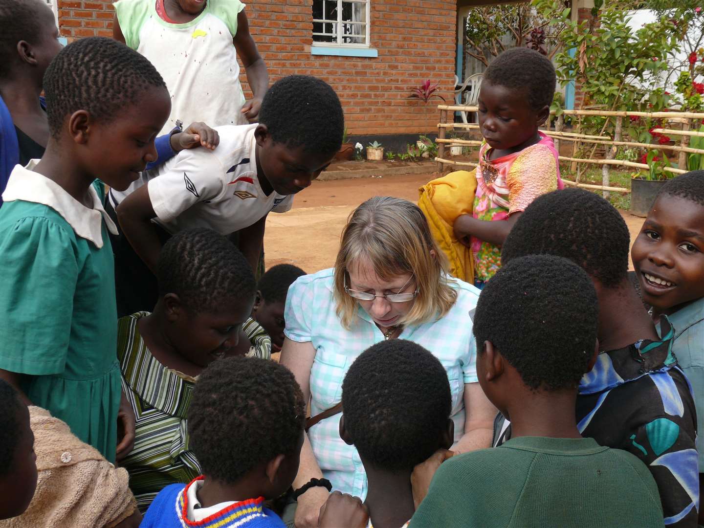 Liz Stewart with orphans who have been helped by FLAG on a previous visit.