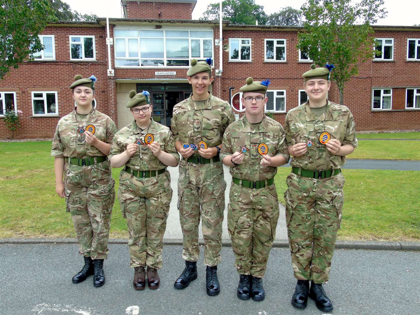 The Inter Service Cadet Rifle Team showing off their badges (from left) Cpl Goodman, Cpl Calder, Cpl Tait, Cpl Hayllar and Cpl Bialkowski.