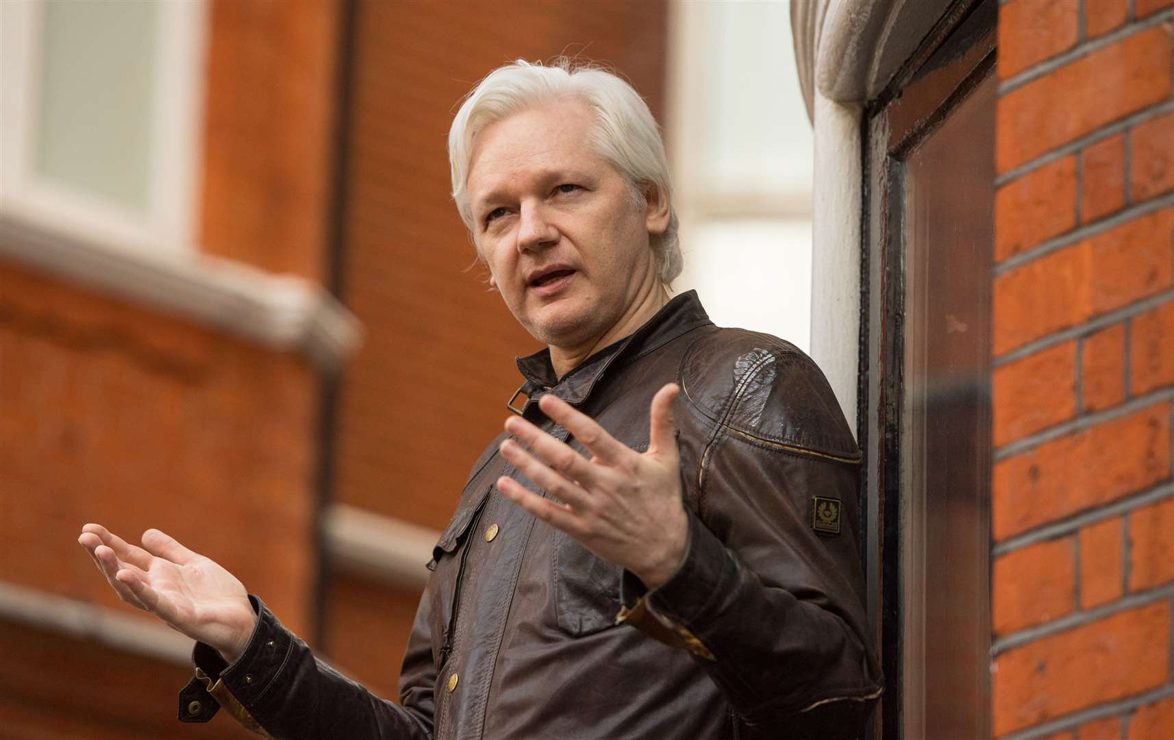 Julian Assange speaking from the balcony of the Ecuadorian embassy in London in 2017 (Dominic Lipinski/PA)