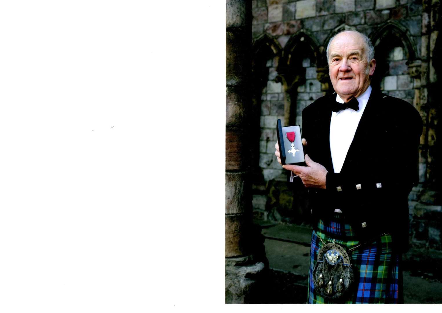 George Alexander with his MBE.