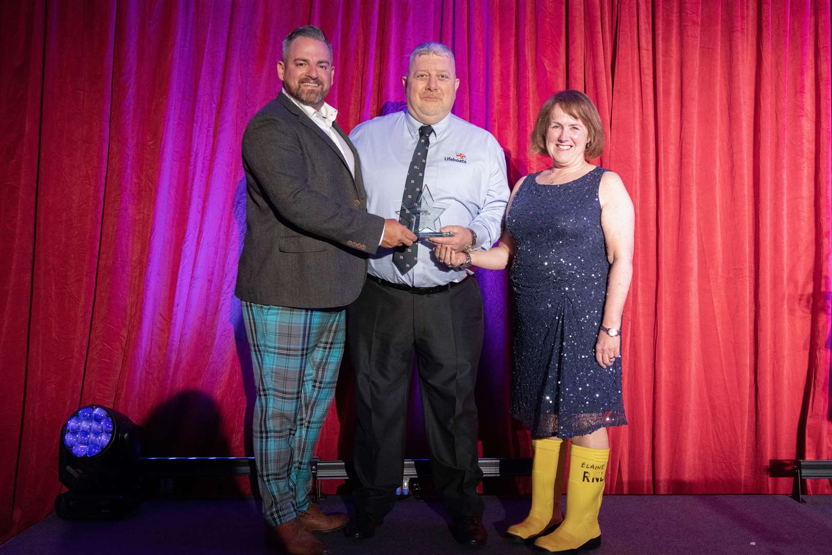 Dave Acton (left), CEO of Motive Offshore, presents the Emergency Services of the Year award to Davie Grant and Anne Scott. Picture: Beth Taylor.