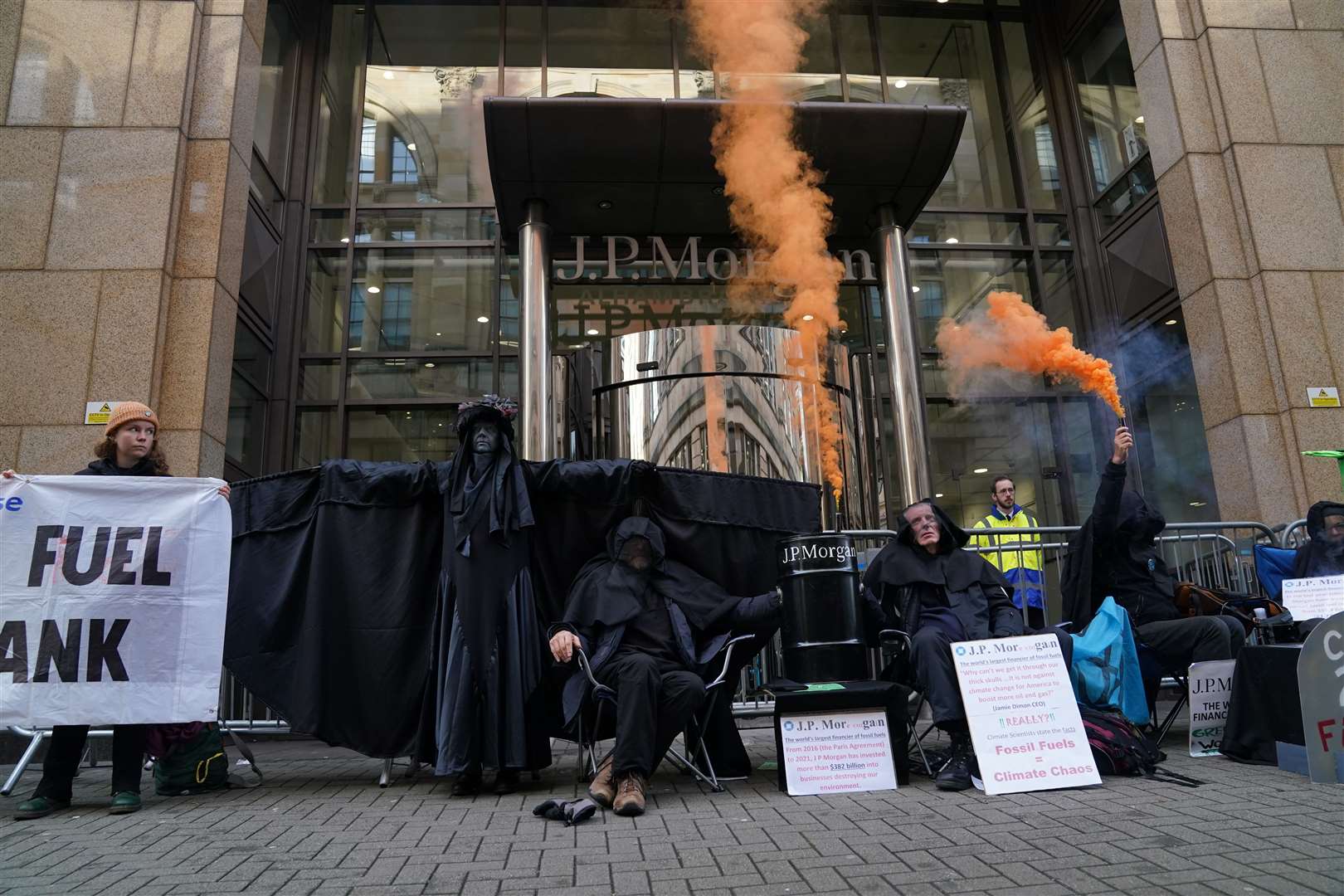The Oil Slicks, an Extinction Rebellion protest troupe, joined the action outside JP Morgan (Andrew Milligan/PA)