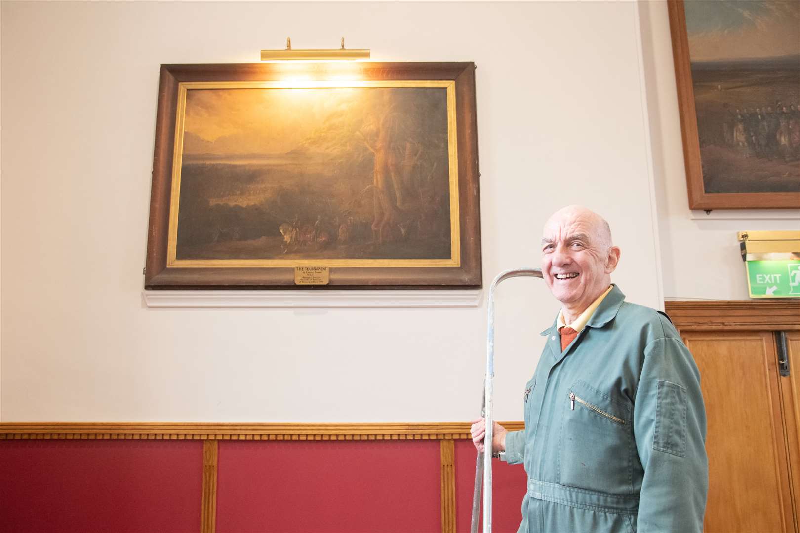 Alex Ross of Forres Heritage Trust alongside the paintings they are looking to restore. Picture: Daniel Forsyth