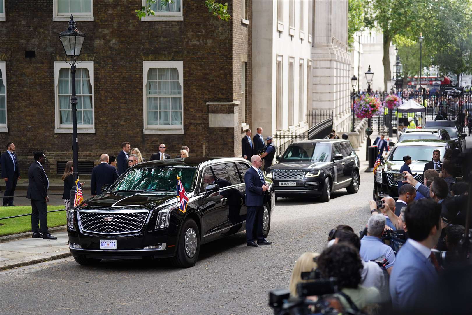 The convoy of cars, including the armoured state car dubbed The Beast, carrying Mr Biden (James Manning/PA)