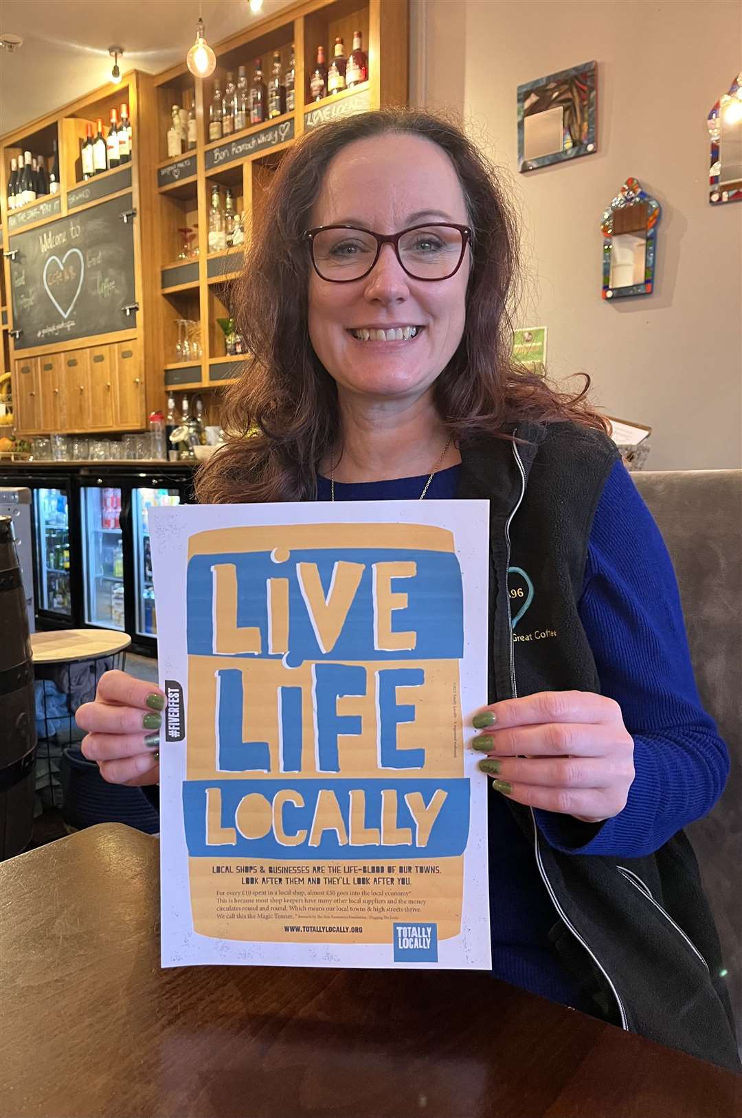 Businesswoman Carrie Custodio promoting Totally Locally's Fiver Fest campaign from Café 1496 on Forres High Street.
