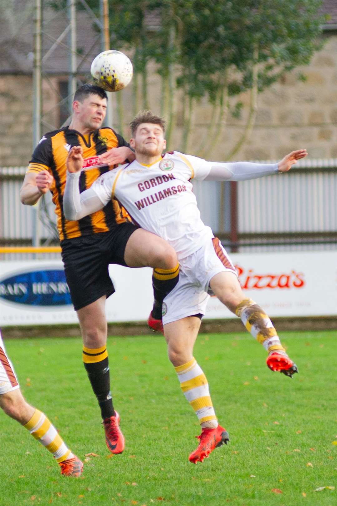 Huntly skipper Glenn Murison and Forres' Jack Grant compete for the ball. Picture: Daniel Forsyth..