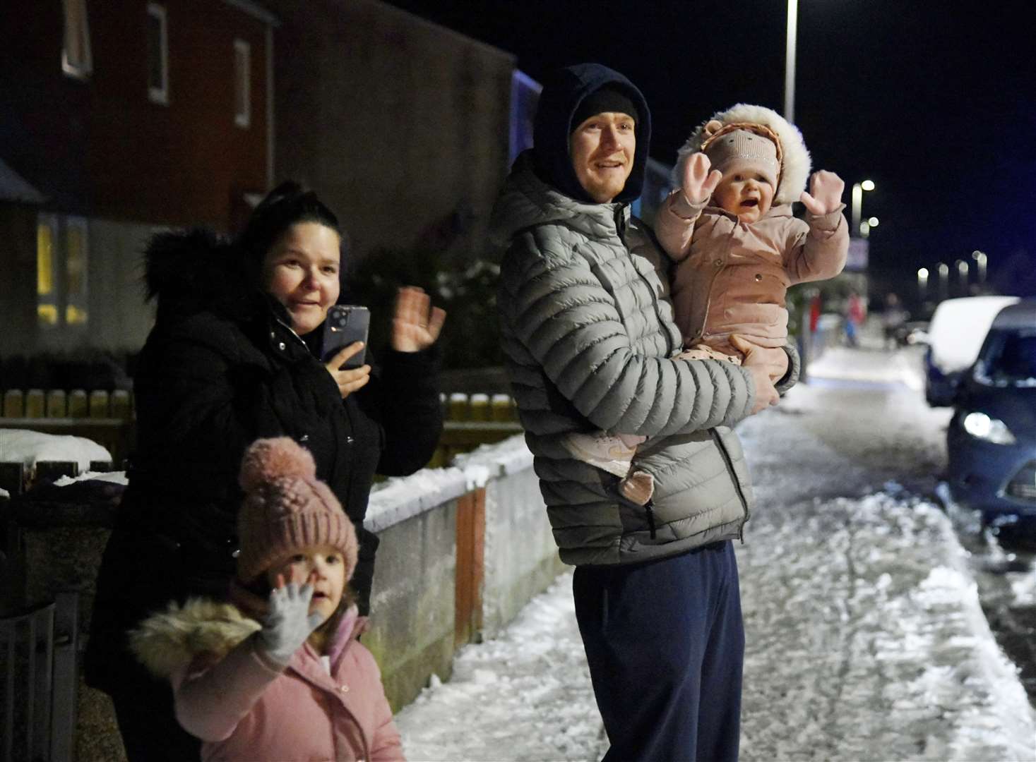 (From left) Tyla-Mae, Robyn, Gregor and Milly McMillan waving to Santa on a run in Forres. Picture: Beth Taylor
