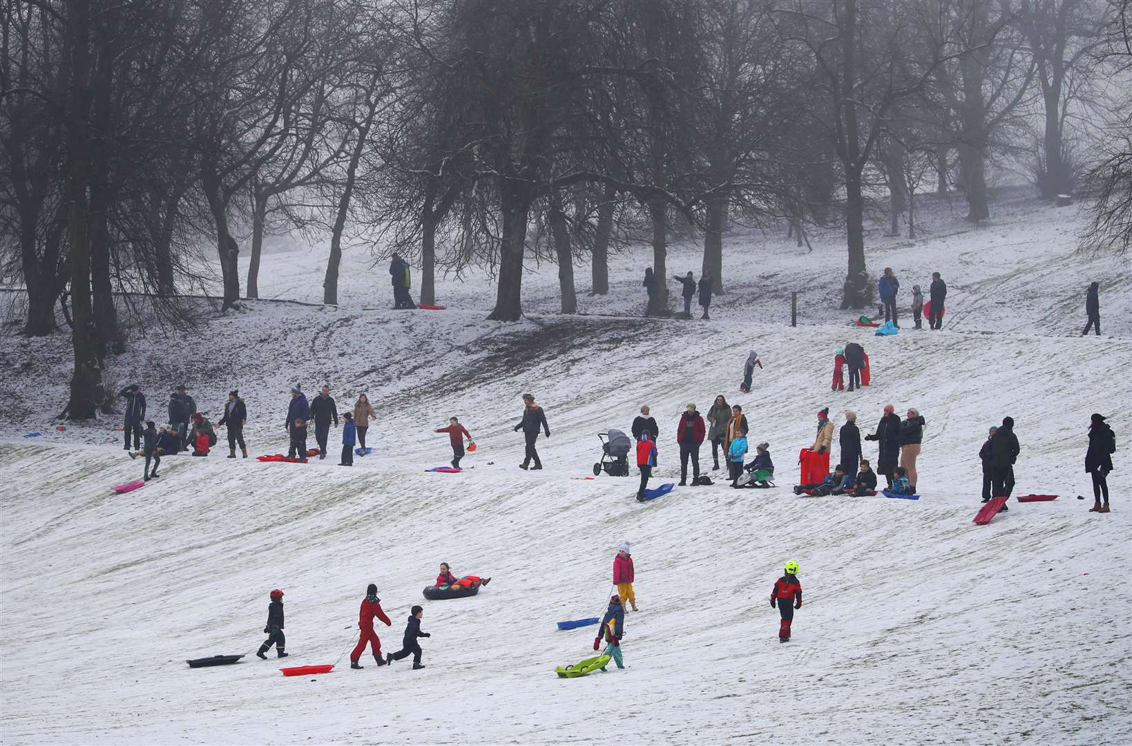 People sledging in Queen’s Park in Glasgow (Andrew Milligan/PA)