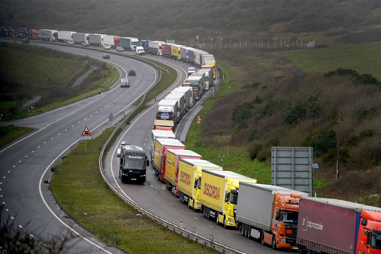 Lorries queue for the Port of Dover along the A20 in Kent (Gareth Fuller/PA)