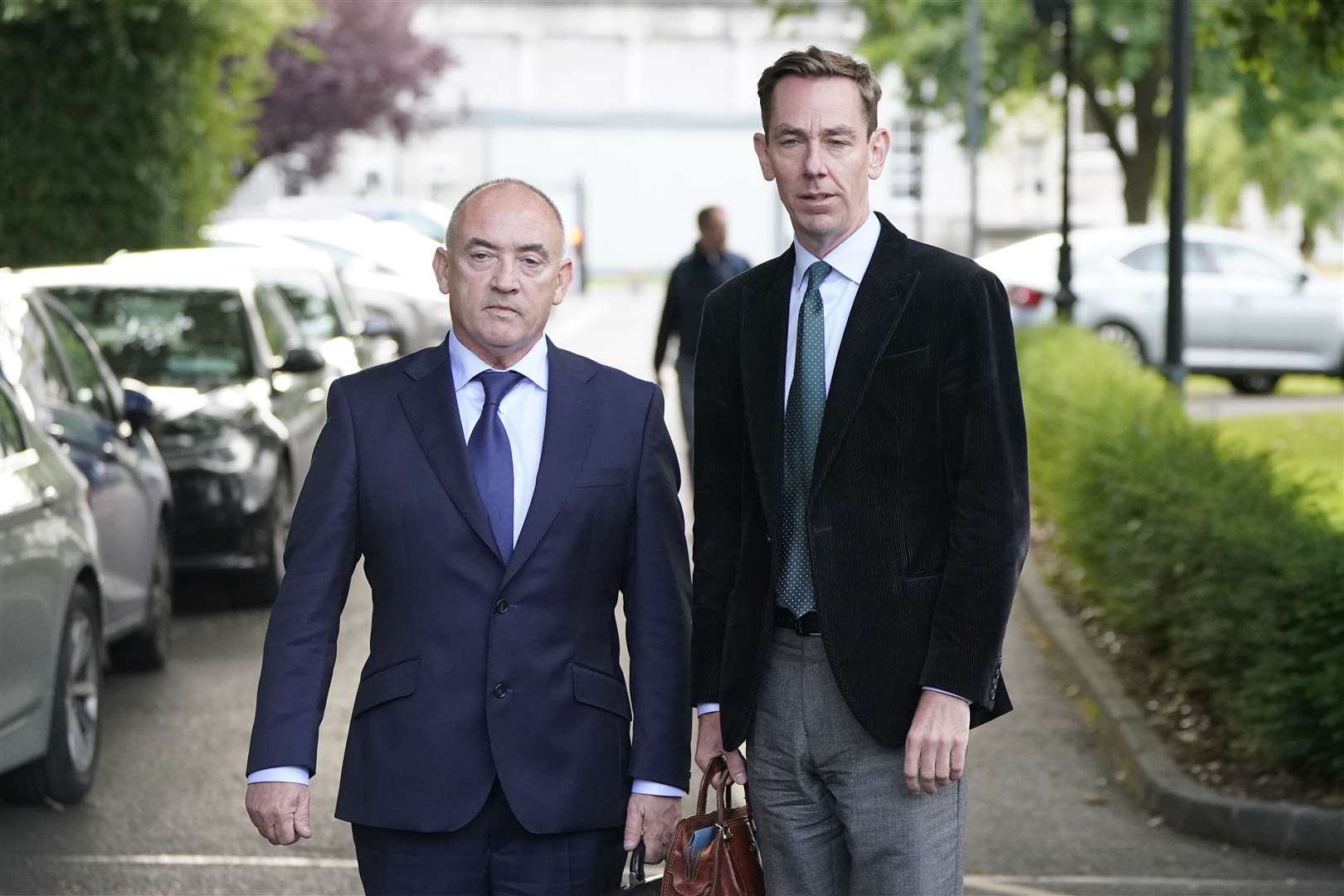 RTE presenter Ryan Tubridy (right) with his agent Noel Kelly leaving Leinster House on Tuesday (Niall Carson/PA)