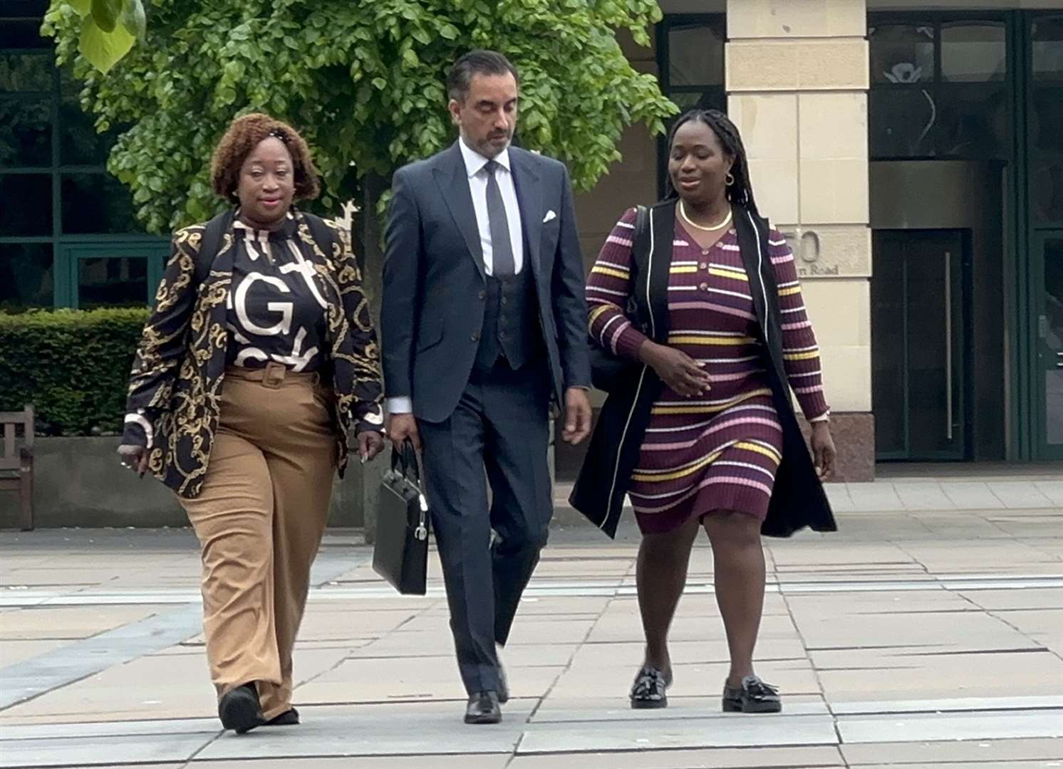 Lawyer Aamer Anwar with members of Sheku Bayoh’s family arriving at the inquiry on Friday (Dan Barker/PA)