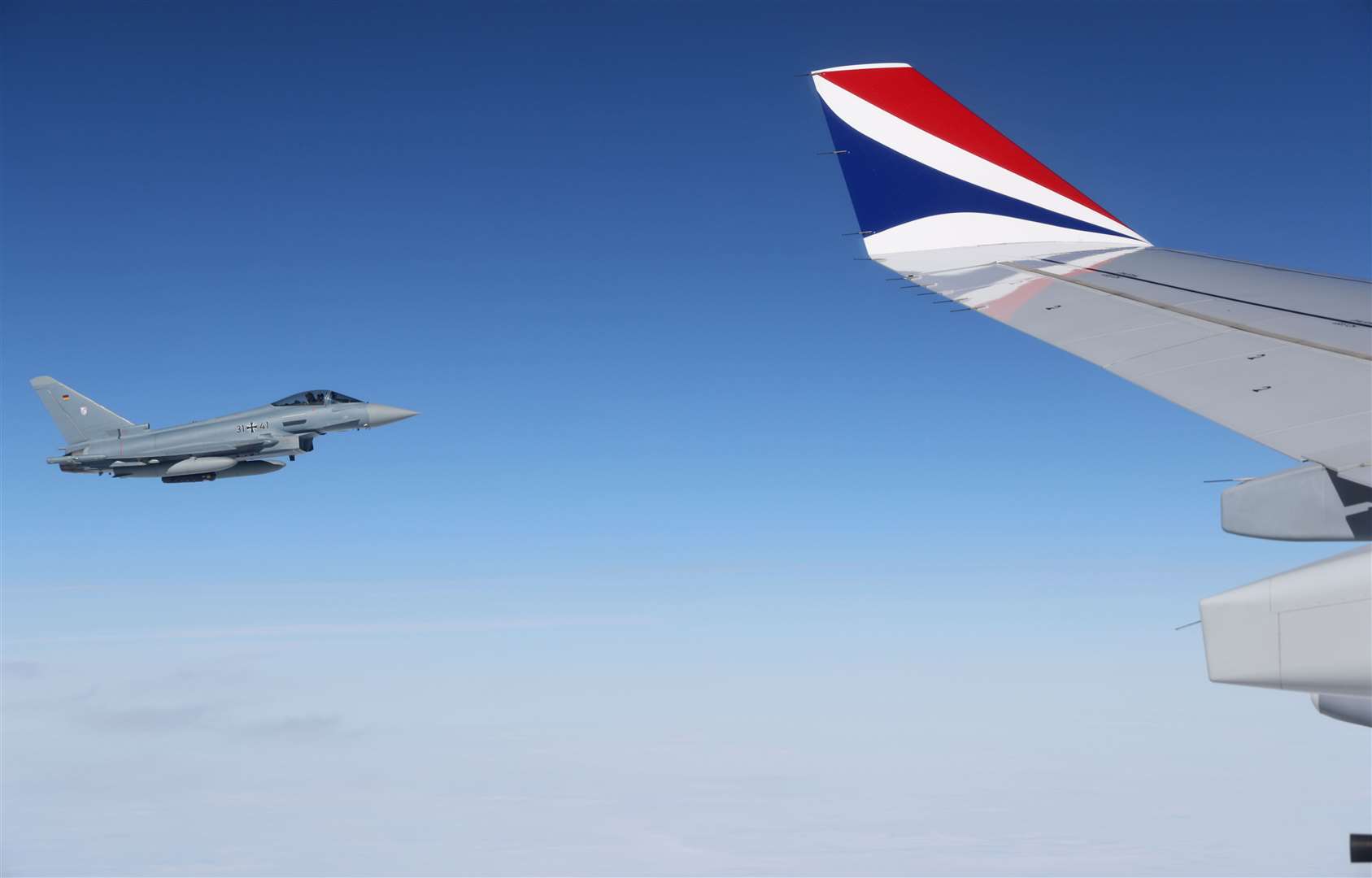 A German Eurofighter Typhoon escorts the aircraft carrying the King and the Queen Consort through German airspace as they travel towards Berlin (Adrian Dennis/PA)