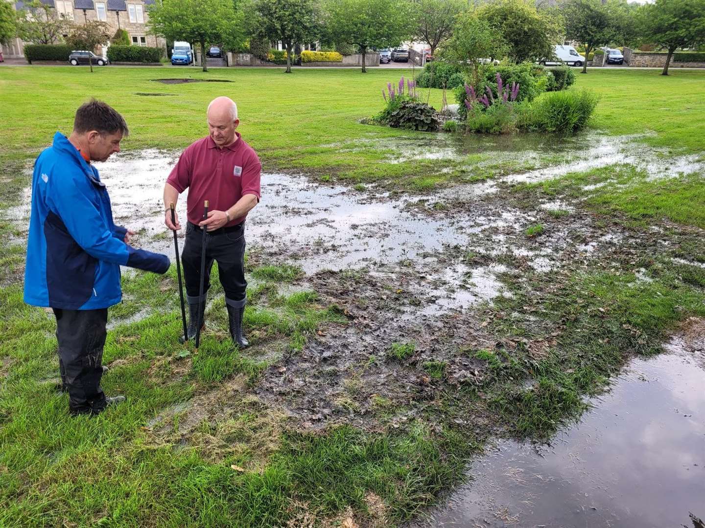 Community council member John Innes (right) inspecting flood damage and sewage between Applegrove and Sanquhar Road.