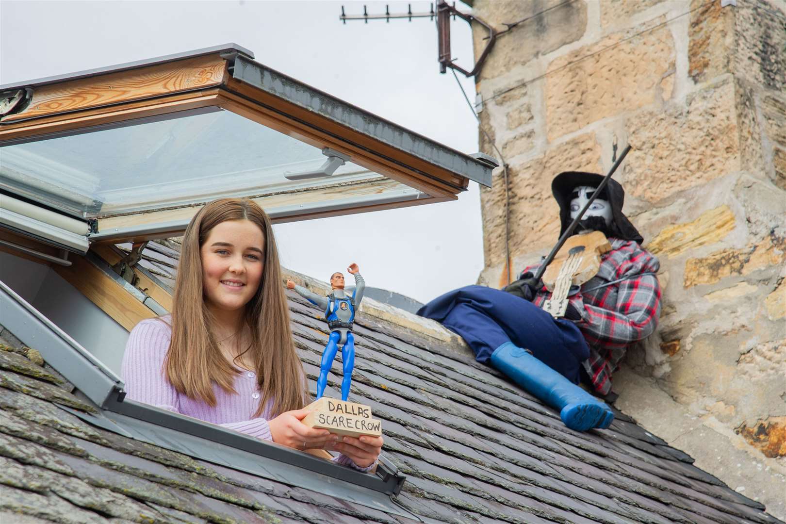Kayla McCallum shows off her family's winning trophy and entry - the Fiddler on the roof. ..2020 Dallas Scarecrow Competition...Picture: Daniel Forsyth..
