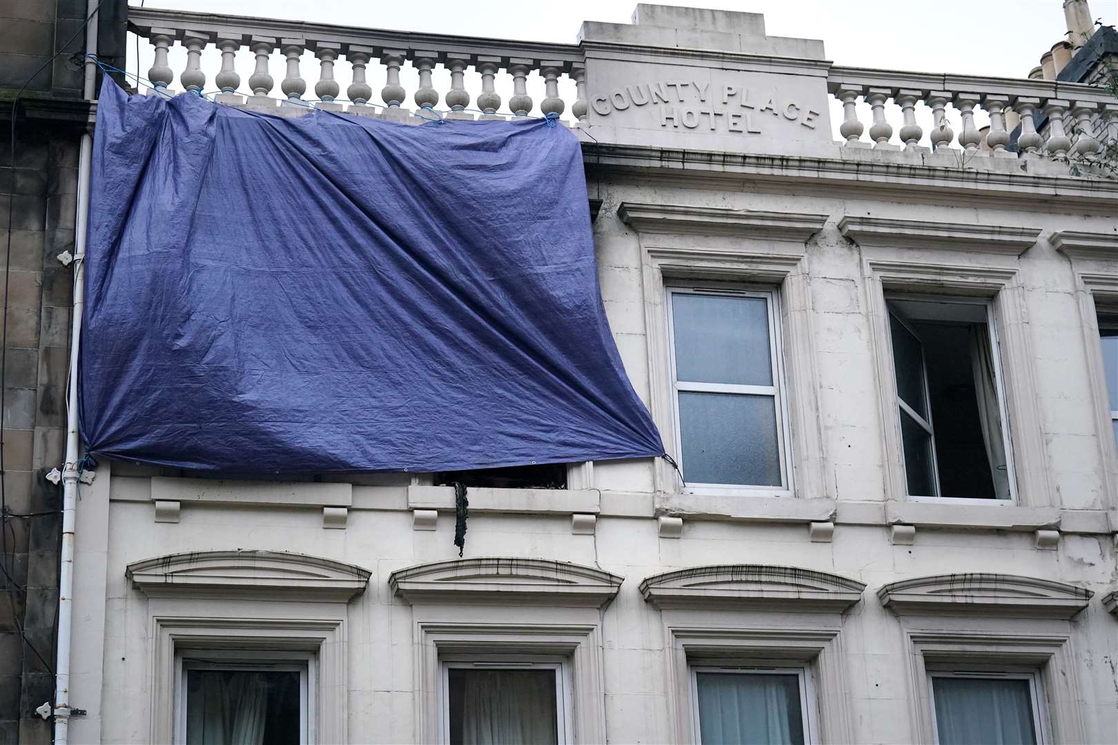 Plastic sheeting covers two windows (Andrew Milligan/PA)