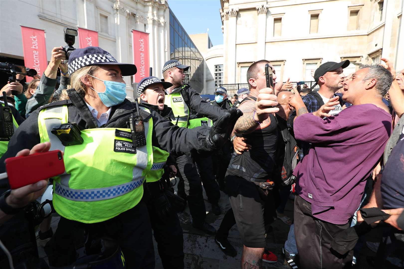 Police talk to demonstrators during an anti-vax protest (Yui Mok/PA)
