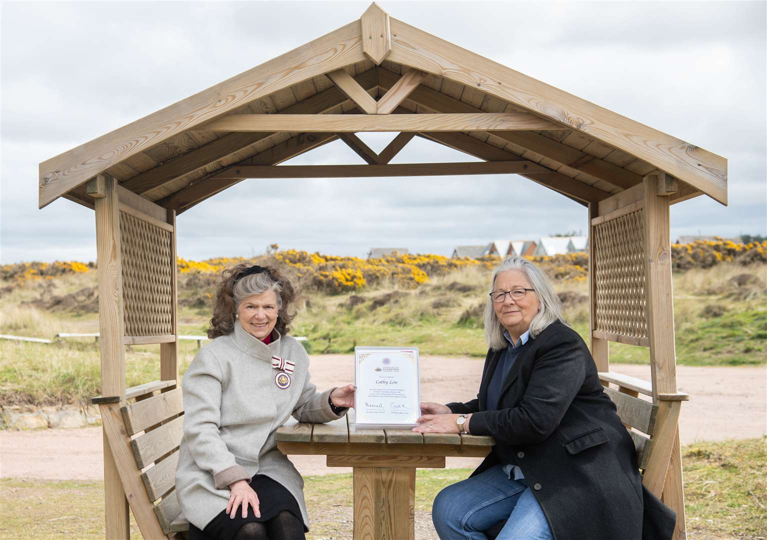 Cathy Low (right) being presented with her certificate by Deputy Lieutenant Sue Finnegan. Picture: Daniel Forsyth