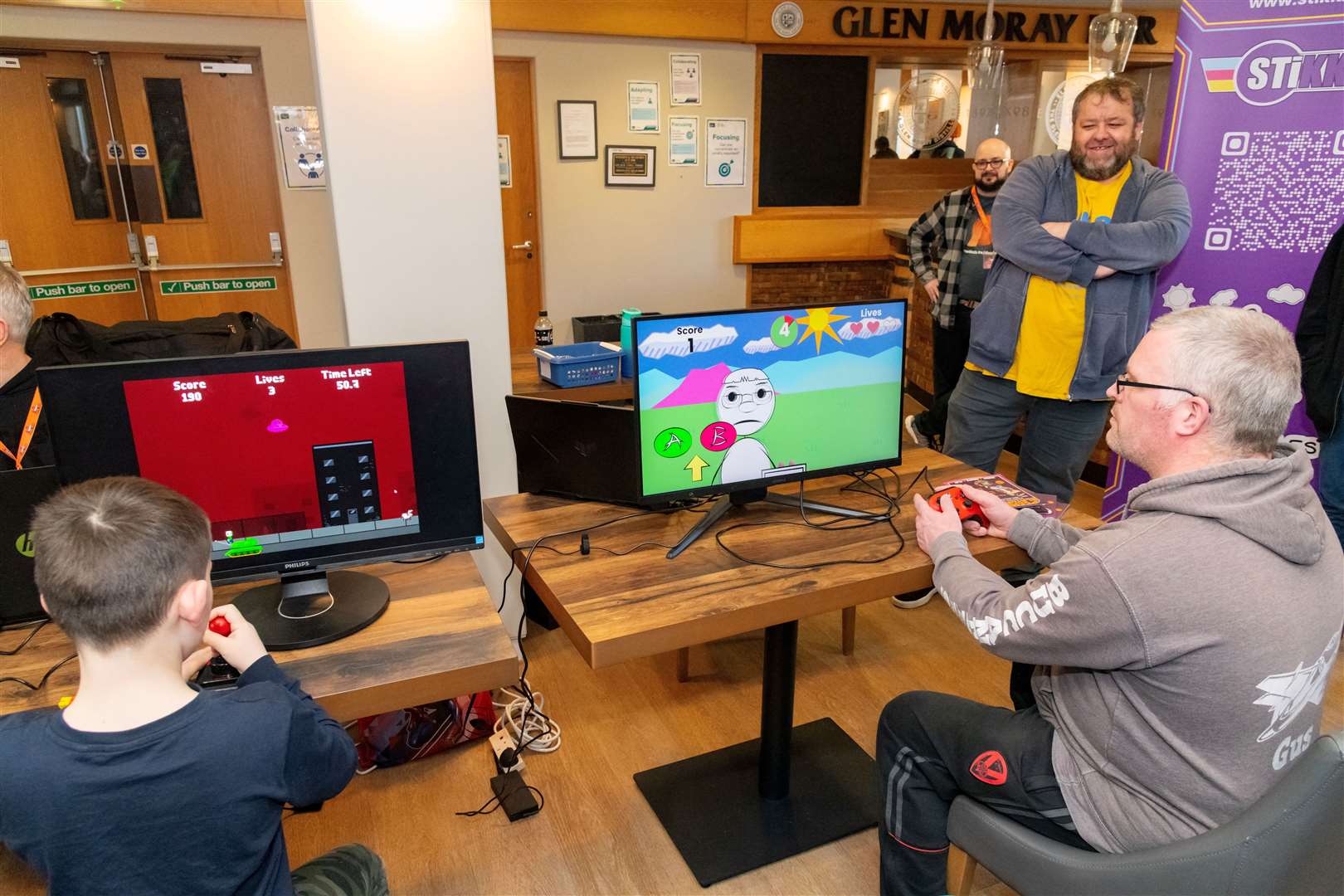 Members of the public enjoying Alien Abduction and Matchupeeshu at the Moray Game Jam 2024 with the theme Up Up and Away held at UHI Moray, in the Beechtree Restaurant. Picture: Beth Taylor