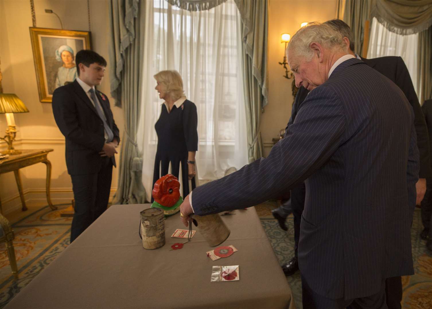 The Prince of Wales is shown a selection of poppy collection items from the past decades (Victoria Jones/PA)