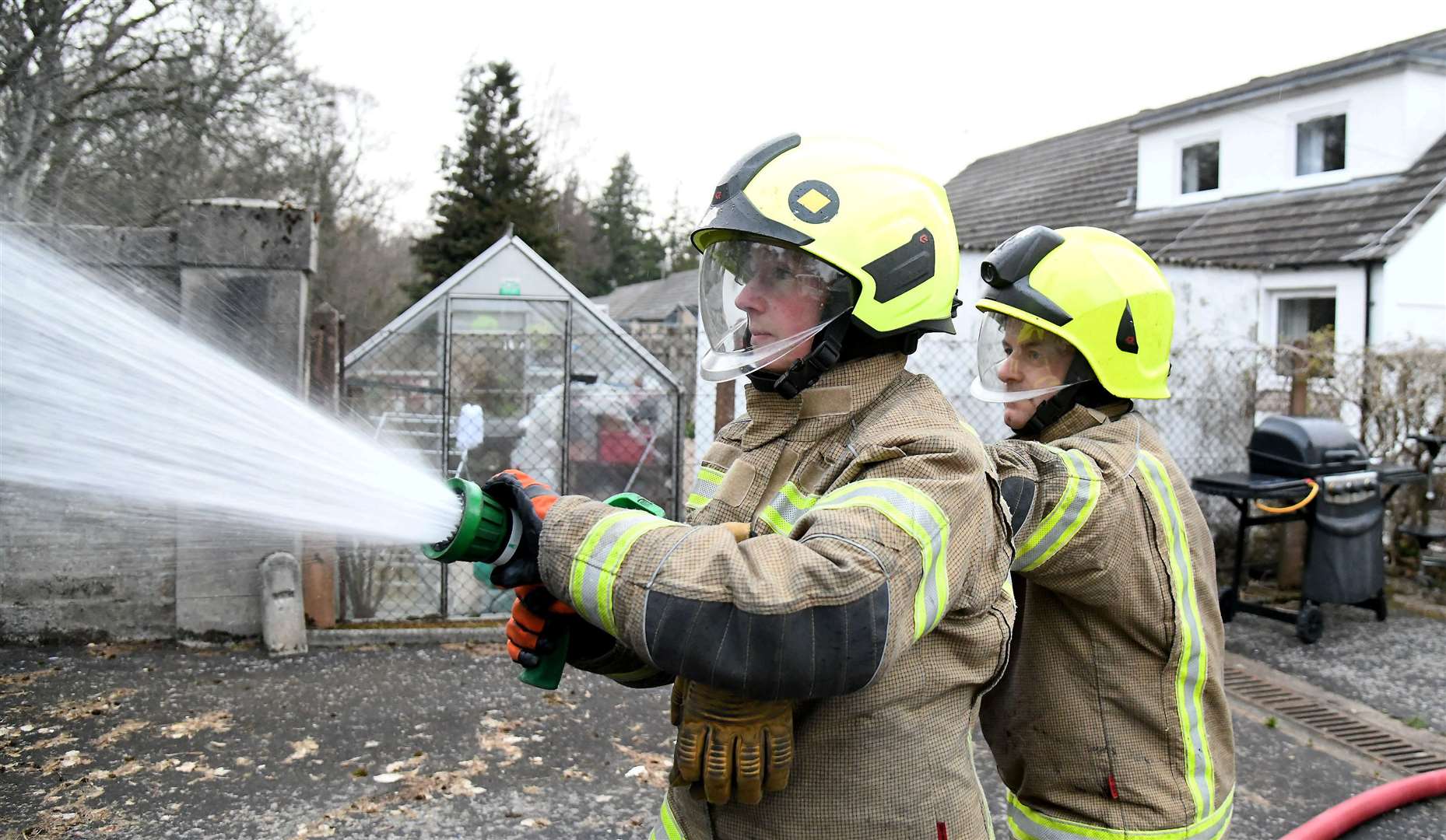 Jane Hay and Stewart Gerrard combine their efforts in this hose drill. Picture: Becky Saunderson