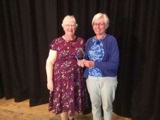 Judith Watts receiving the Centenary Trophy from Federation chairwoman, Sybil Stuart.