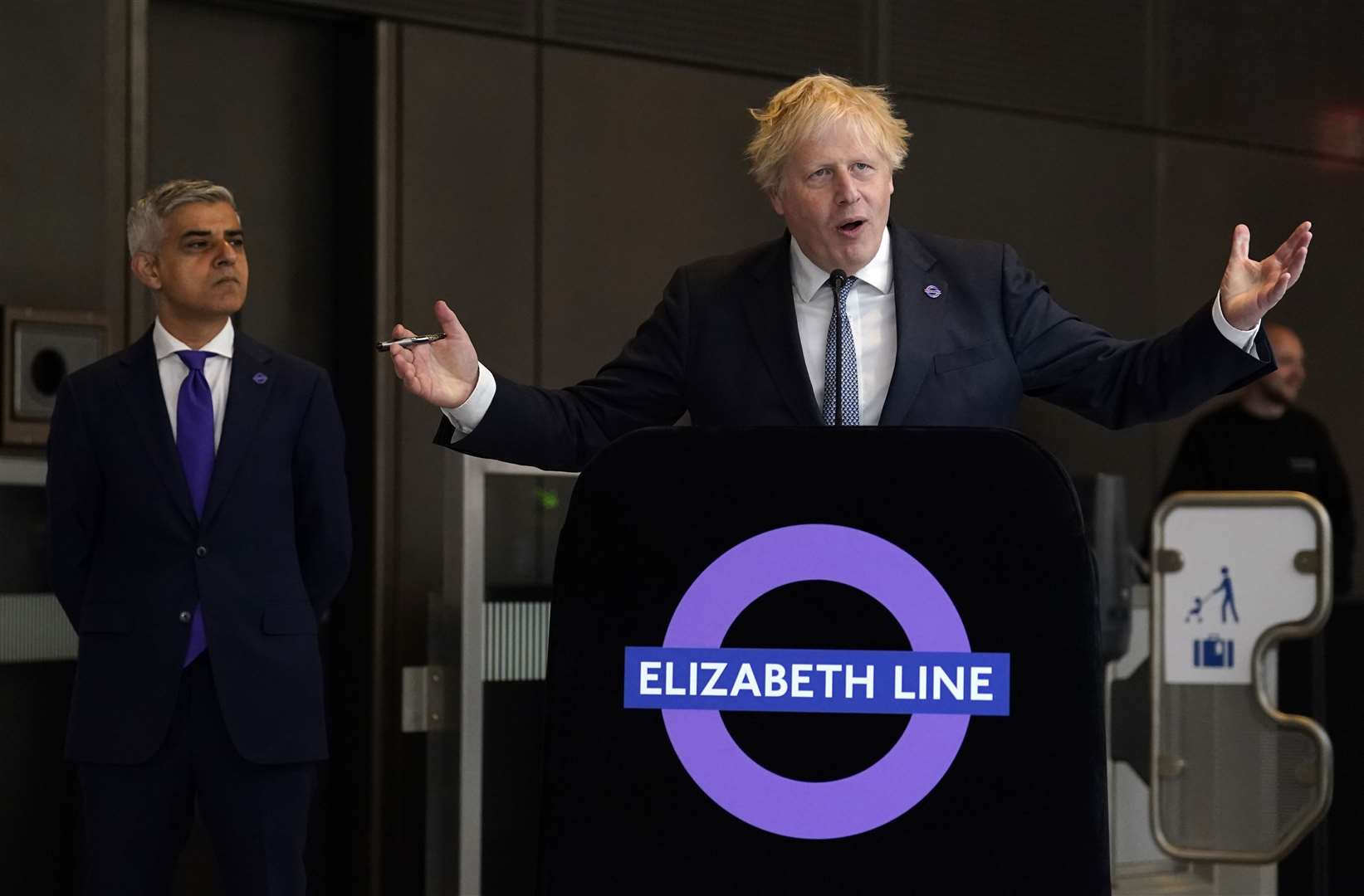 Mayor of London Sadiq Khan looks on as Prime Minister Boris Johnson makes a speech at Paddington station in London to mark the completion of London’s Crossrail project (Andrew Matthews/PA)