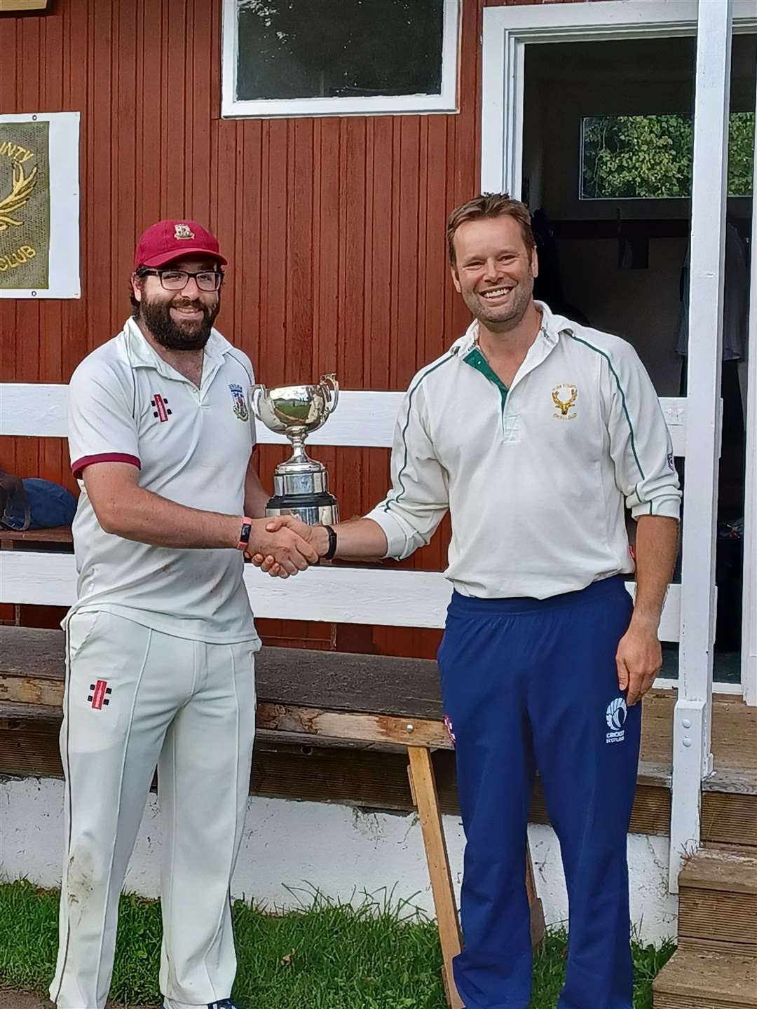 Skipper Pal Dhami receives the cup.