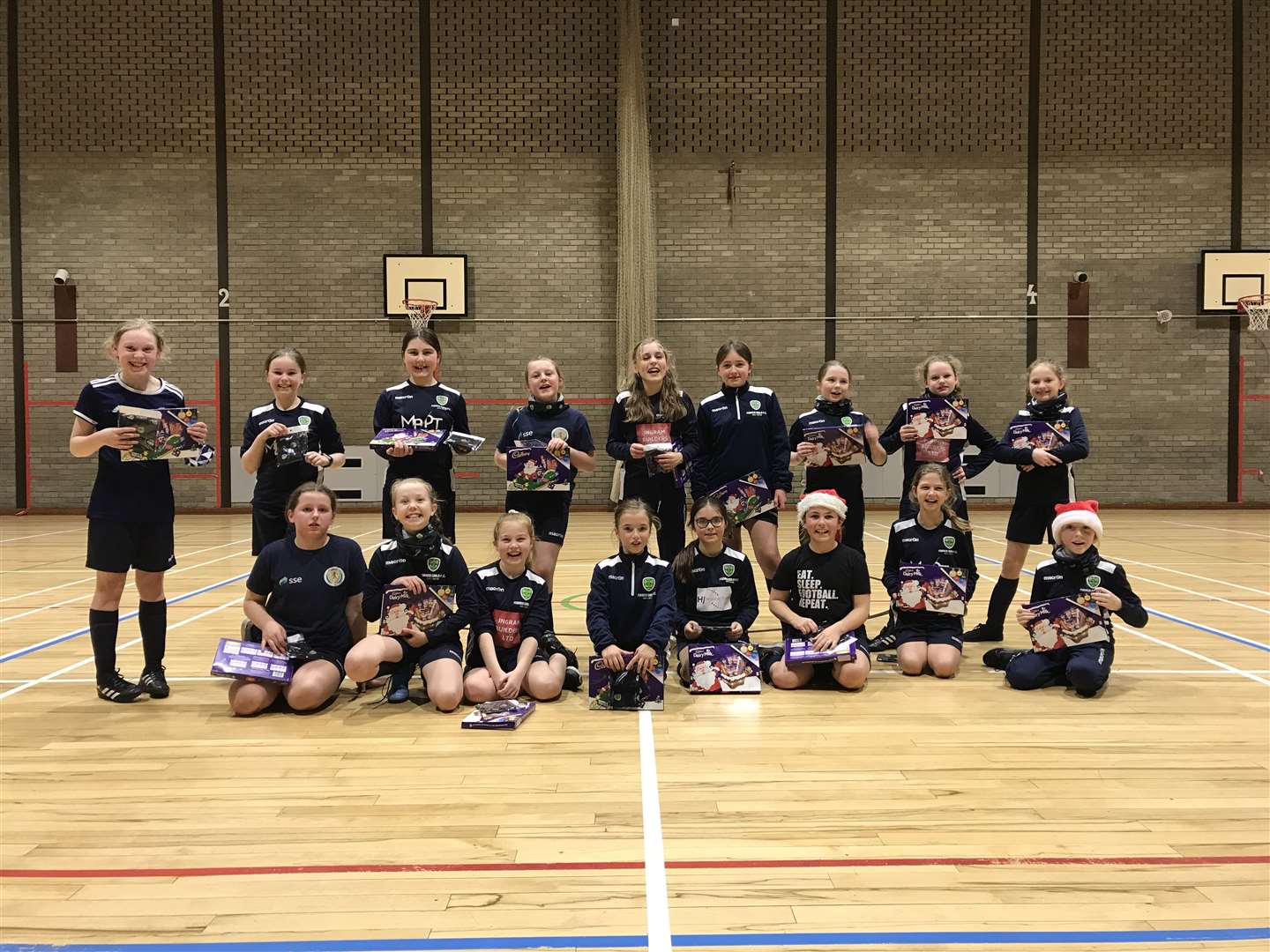 Forres Girls FC under-11 squad with their gifted selection boxes and snoods at their last session in Forres House Community Centre before the Christmas break.